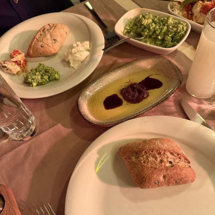 Masaya yayılmış meze tabakları ve kadehler.